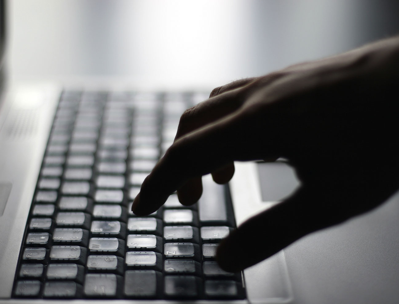 Photo of someone typing on a laptop computer